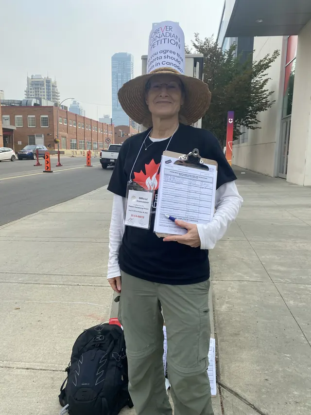 Volunteer helping a supporter complete the Forever Canadian petition.